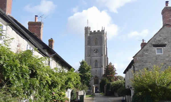 Views over cobbled lane leading to St Barnabas Church, Queen Camel